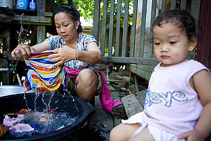 <strong>Wash day</strong>: Much labor in Long Pahangai is done by hand, without the benefit of electricity. The micro-hydro project should improve efficiency and free time for other livelihood activities. © WWF / Simon Rawles Wash day: Much labor in Long Pahangai is done by hand, without the benefit of electricity. The micro-hydro project should improve efficiency and free time for other livelihood activities.